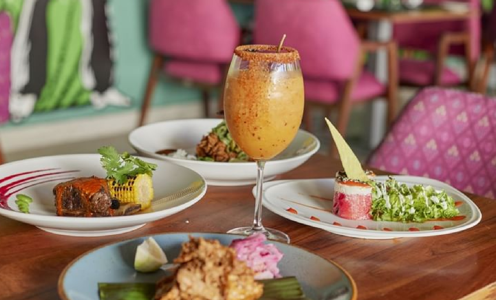 Mexican cuisine on a table with an orange drink